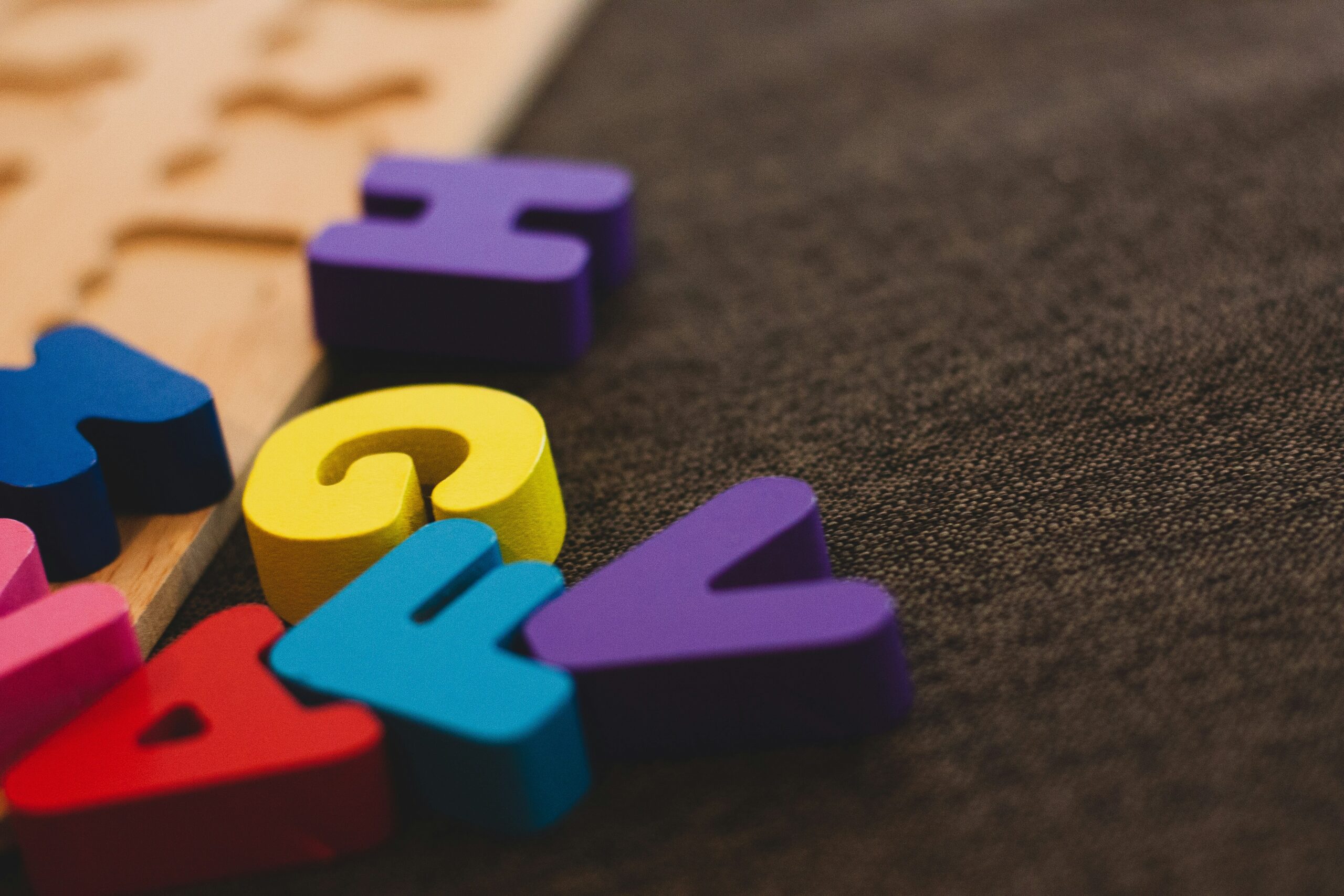 Colourful letter puzzle pieces