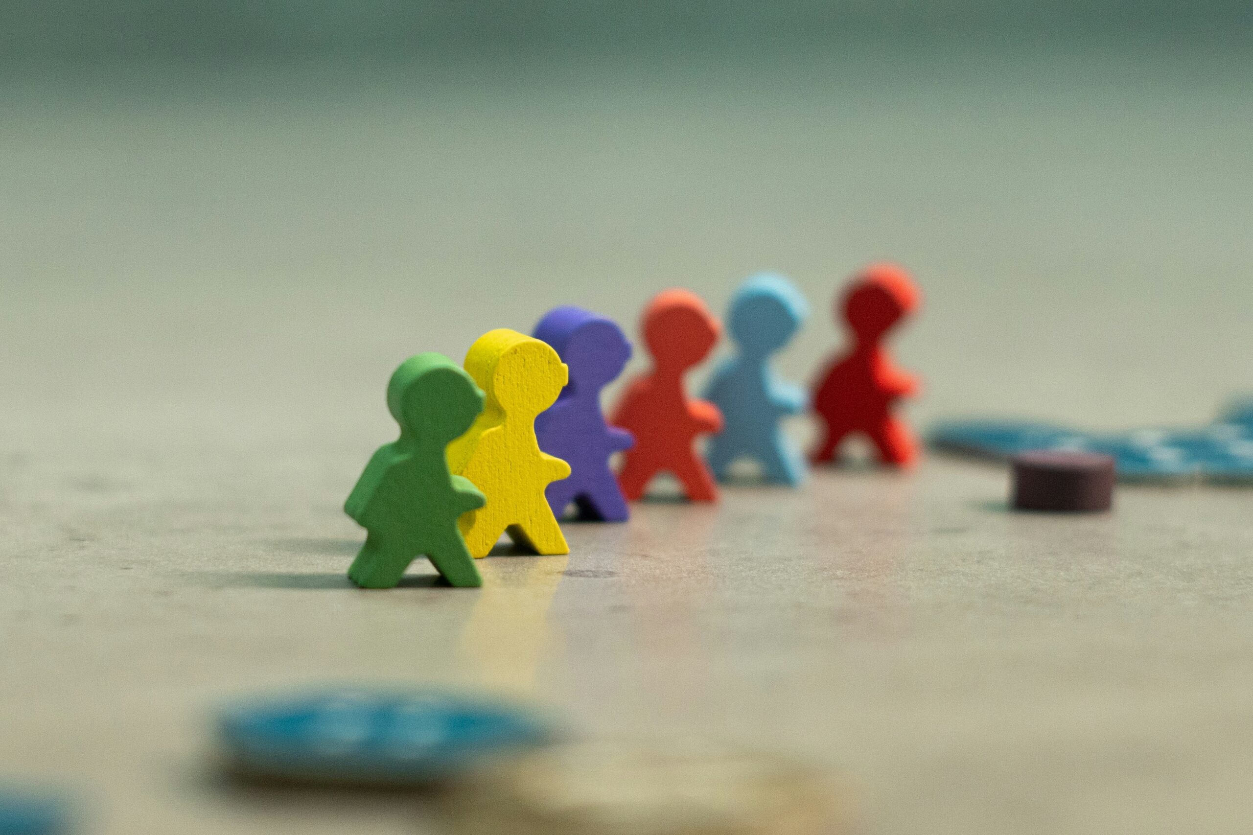 Colourful wooden figure pieces in a row